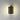 ET2 Omni Black wall sconce lit on a gray wall, light spilling up and down