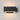 ET2 Blok compact aluminum outdoor wall sconce, 9 x 3.75 in Black, lit with light washing up and down a gray wall