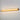 ET2 Loop wall sconce, 36 in Gold, lit with warm amber light on a grey wall