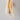ET2 Manta 17 in Gold wall sconce, lit, on a gray wall