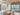 ET2 Soji lantern glass wall sconce on the kitchen wall beside a dining room with a wood-plank ceiling