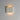 ET2 Delphi fluted concrete wall sconce, Chalk White, lit with warm glow on a gray wall