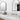 ET2 Elisse black arch mirrors with lit frames above a marble bathroom vanity with wall-mounted faucets