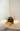 Modern desk lamp with brass frame and natural cardboard shade