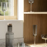 FUUMI water carafe in a styled setting | FUUMI tinted glassware by blomus