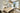 ET2 Flute brass tubes over a long pale dining table with sheer curtained windows behind