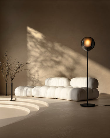Penta Glo floor lamp with mirroring glass sphere beside a sofa in a modern living room