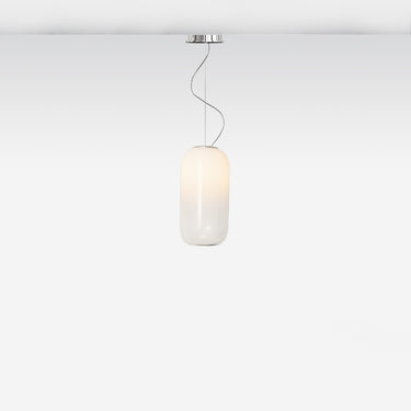 Gople Mini Pendant Light by Artemide hanging in a dining area