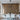 ET2 Groove Black ring pendant over a long white dining table in front of a wood-slat wall