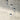 ET2 Highball glass cylinder pendants with dark caps hung at different heights in front of a gray concrete wall