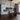 ET2 Hover batons hung in a loft kitchen with an island, stools and tall black shelving