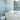 ET2 Inca flush mount reflected in a mirror above a white vanity in a bathroom
