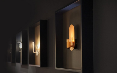 Vertical copper Innermost Brixton industrial wall lamp, providing warm up-lighting for narrow corridors.