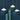 Three pendant lights hanging against a dark blue wall with green cylindrical objects.