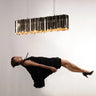 Modern linear suspension light by Tom Kirk with intricate etched facets.