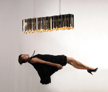 Modern linear suspension light by Tom Kirk with intricate etched facets.