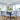 ET2 Larmes LED linear teardrop pendant over a dining table with gray upholstered chairs
