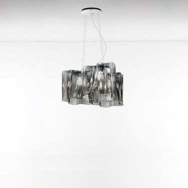 A modern Artemide Logico Mini Triple nested suspension lighting fixture with LED-T lamps, featuring a milky white glass shade with grey smoke, suspended from a chain.