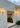 Lyndon outdoor wall lamp by Oluce beside a courtyard entrance, lifestyle view