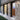 Lyndon 161 mini outdoor wall lamp by Oluce mounted on a building facade, lifestyle view