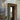 Lyndon 161 mini outdoor wall lamp by Oluce beside a glass-block doorway, lifestyle view