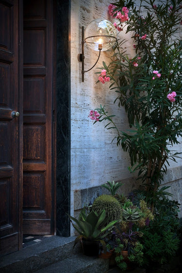 Lyndon outdoor wall lamp by Oluce with opaline globe and black lacquered metal frame for gardens