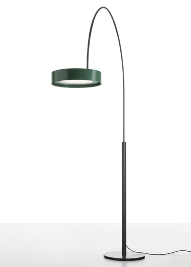 Oluce Berlin-Out arched floor lamp with a green round shade and black stem on a light studio floor