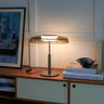 Oluce Dora table lamp in black nickel with smokey grey glass shade, studio shot