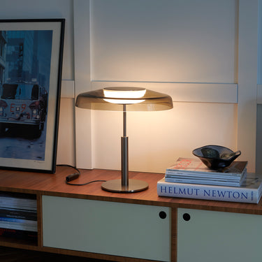 Oluce Dora table lamp in black nickel with smokey grey glass shade, studio shot