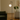 Modern Artemide NH floor lamp with white glass globe diffuser and brass ring in a contemporary living room