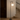 Designer NH floor lamp by Artemide featuring black metal pole and round glass shade for hotel reception areas
