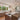 ET2 Nucleus clear glass orb pendants hanging over a kitchen island with white stools