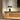 Satin bronze Atollo table lamp by Oluce on a console
