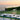 Oluce Berlin-Out table lamp on an outdoor dining table at sunset