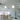 Oluce Berlin-Out arched floor lamp beside a white dining table