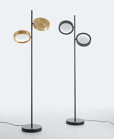 Oluce Berlin floor lamps in anodized brass and matt black on a light studio background