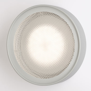 Oluce Berlin-Out round wall lamp in matt aluminium with a textured acrylic disc on a white background