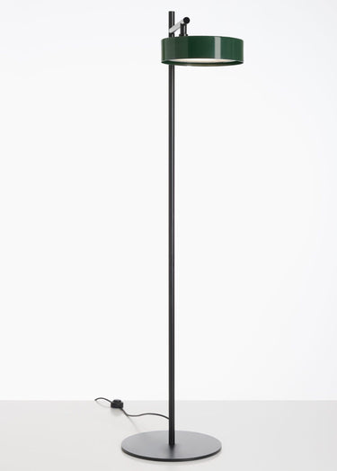 Oluce Berlin-Out outdoor floor lamp with a green round head and black stem on a light studio floor