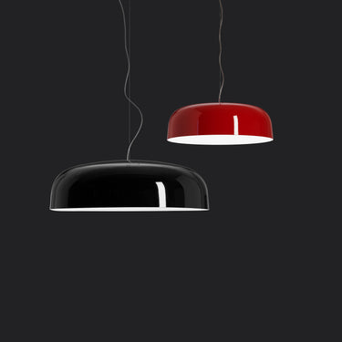 Oluce Canopy pendant lamps in black and scarlet red hanging against a dark background