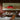 Oluce Canopy scarlet red pendant lamp above a steel dining table in a warm brown room