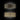 Oluce Lens wall lamp in anodic bronze, front view