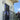 Lyndon outdoor wall lamp by Oluce beside a balcony window, lifestyle view