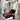 Oluce Pascal floor lamp next to a burgundy lounge chair in a white sculptural interior