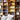 Oluce Pascal floor lamp in front of a library bookcase with the two cones lit