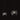 Two Oluce The Globe pendants in satin nickel, small and large, on a dark studio background