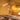 Ilo horizontal LED pendant lighting a dining table in a warm ochre room with dried flowers