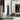 Conmoto Peter Maly Fireside Tools with Floor Stand, next to an open fireplace with a log holder
