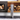 Conmoto Peter Maly Fireside Tools with Floor Stand, in front of a stacked firewood shelf