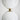 Minimalist brass hanging light for artistic lighting statement in residential gallery space