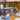 ET2 Quartz crystal pendants above a dining table in an open kitchen with wood cabinets and blue sofa
